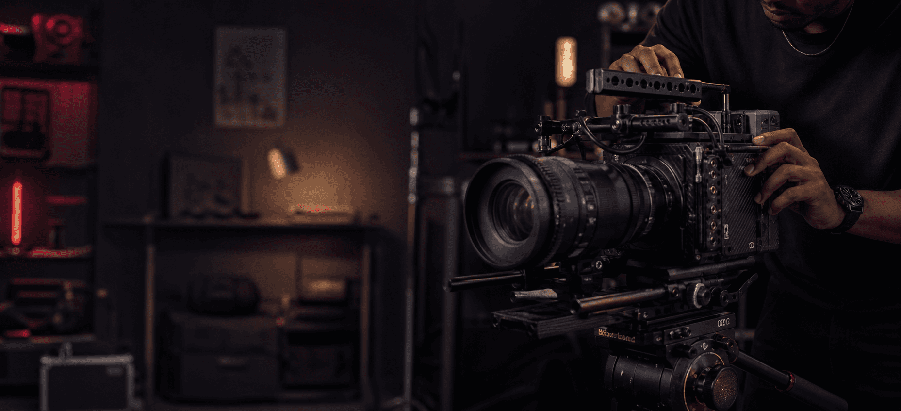 A filmmaker preparing a cinema camera in a studio